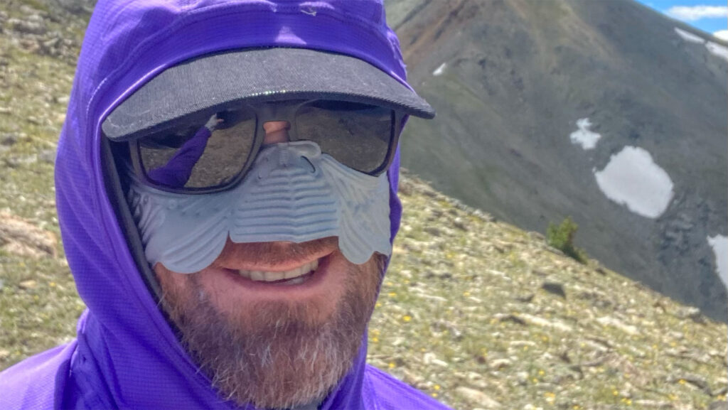 The author showing some sun protection strategies from his successful 2023 North to South trip, including sun hoodie, Cat 4 glacier glasses, face mask, and wide brimmed hat.